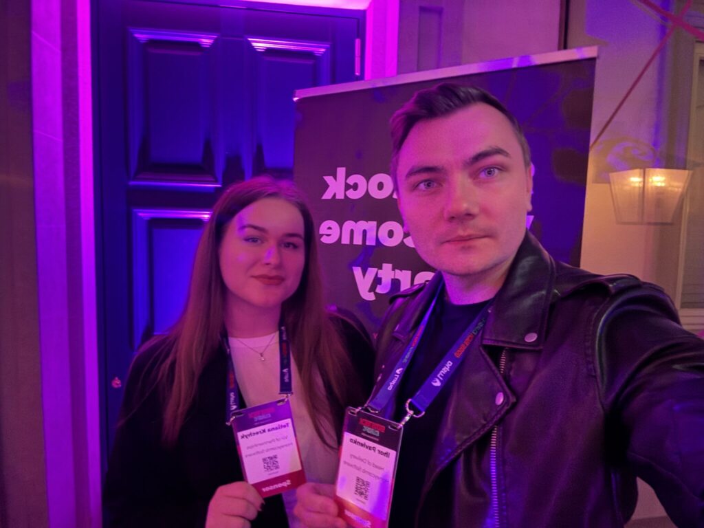 Tetiana Krechyk and Ihor Pavlenko representing Honeycomb Software at a tech event, meeting clients and discussing product scalability.